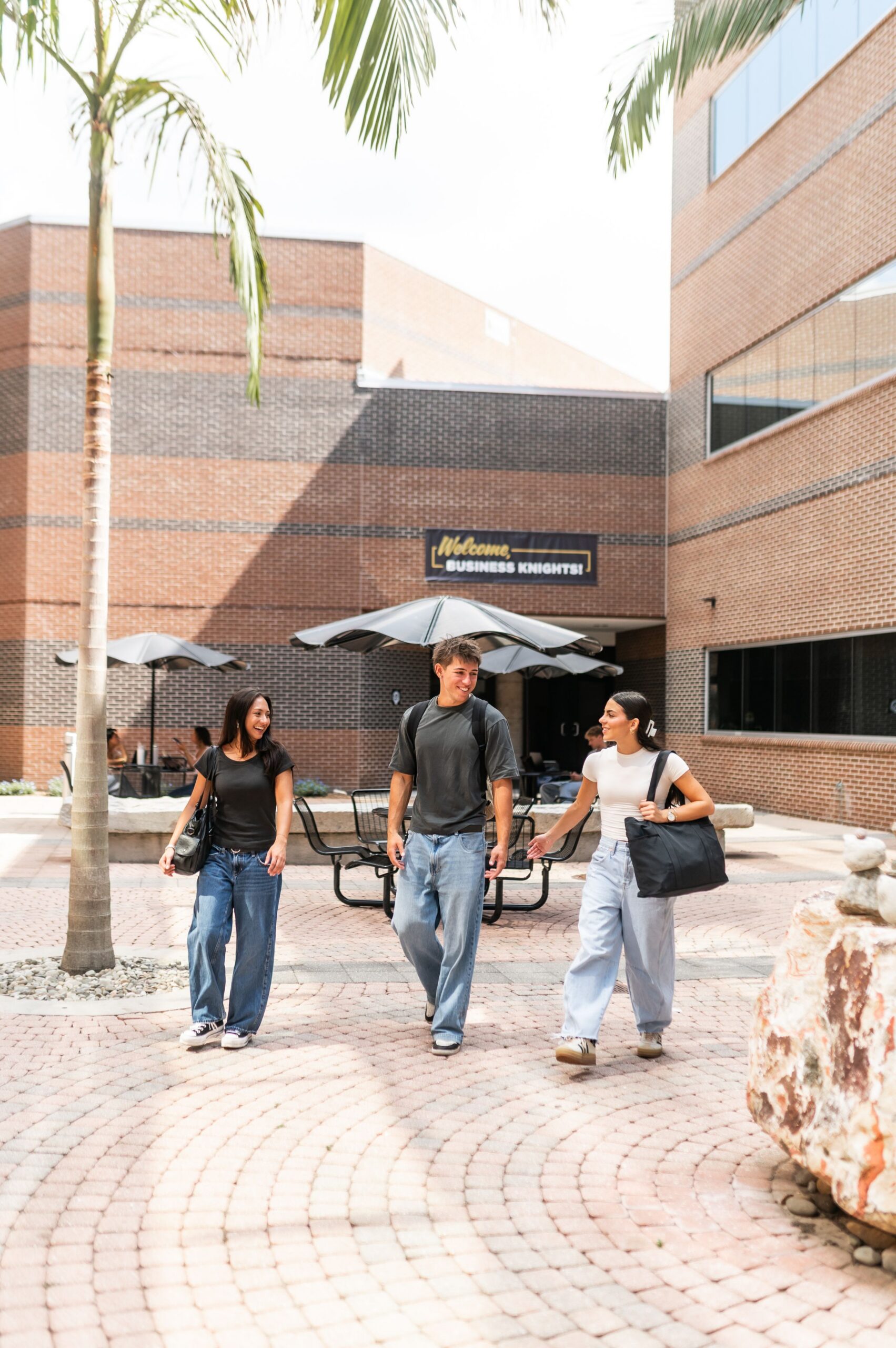Business students crossing campus courtyard