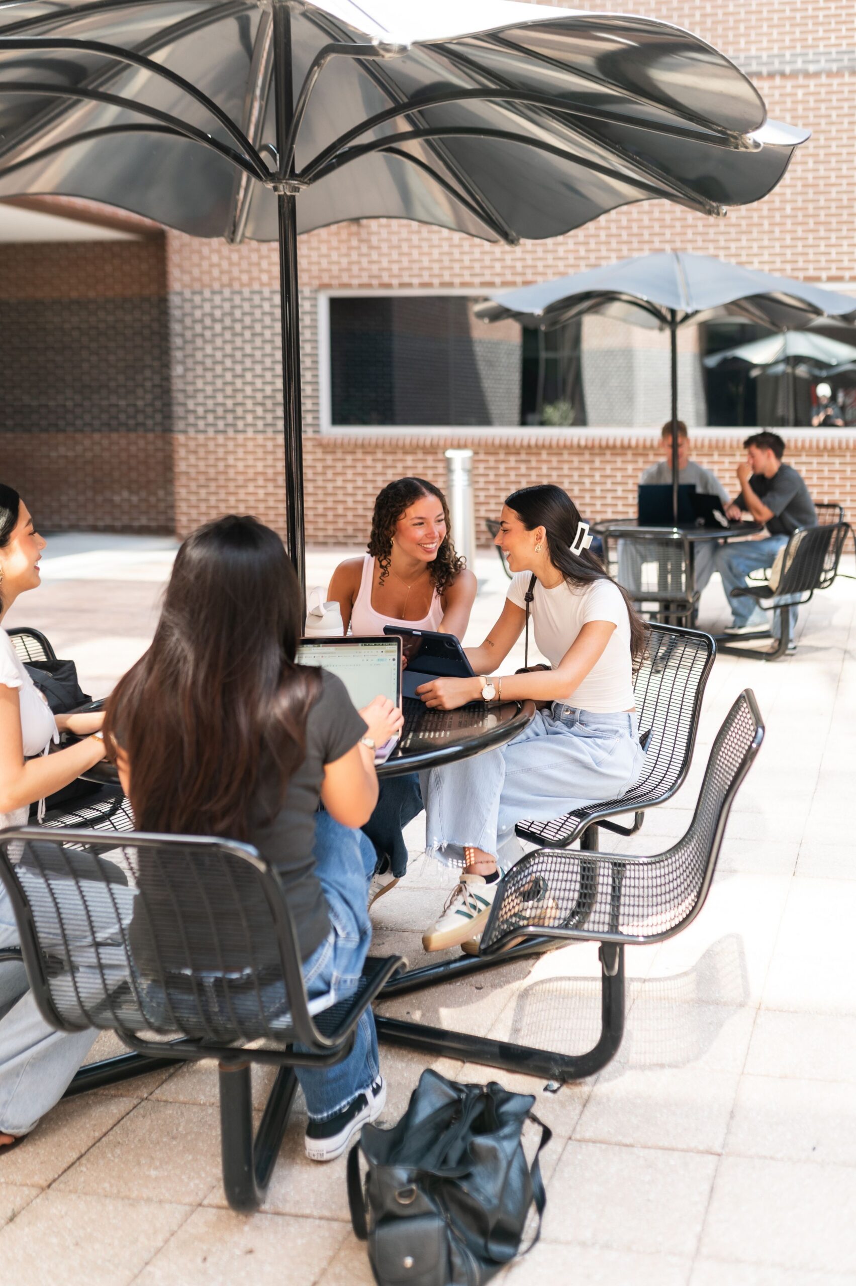 college students studying at patio table scaled