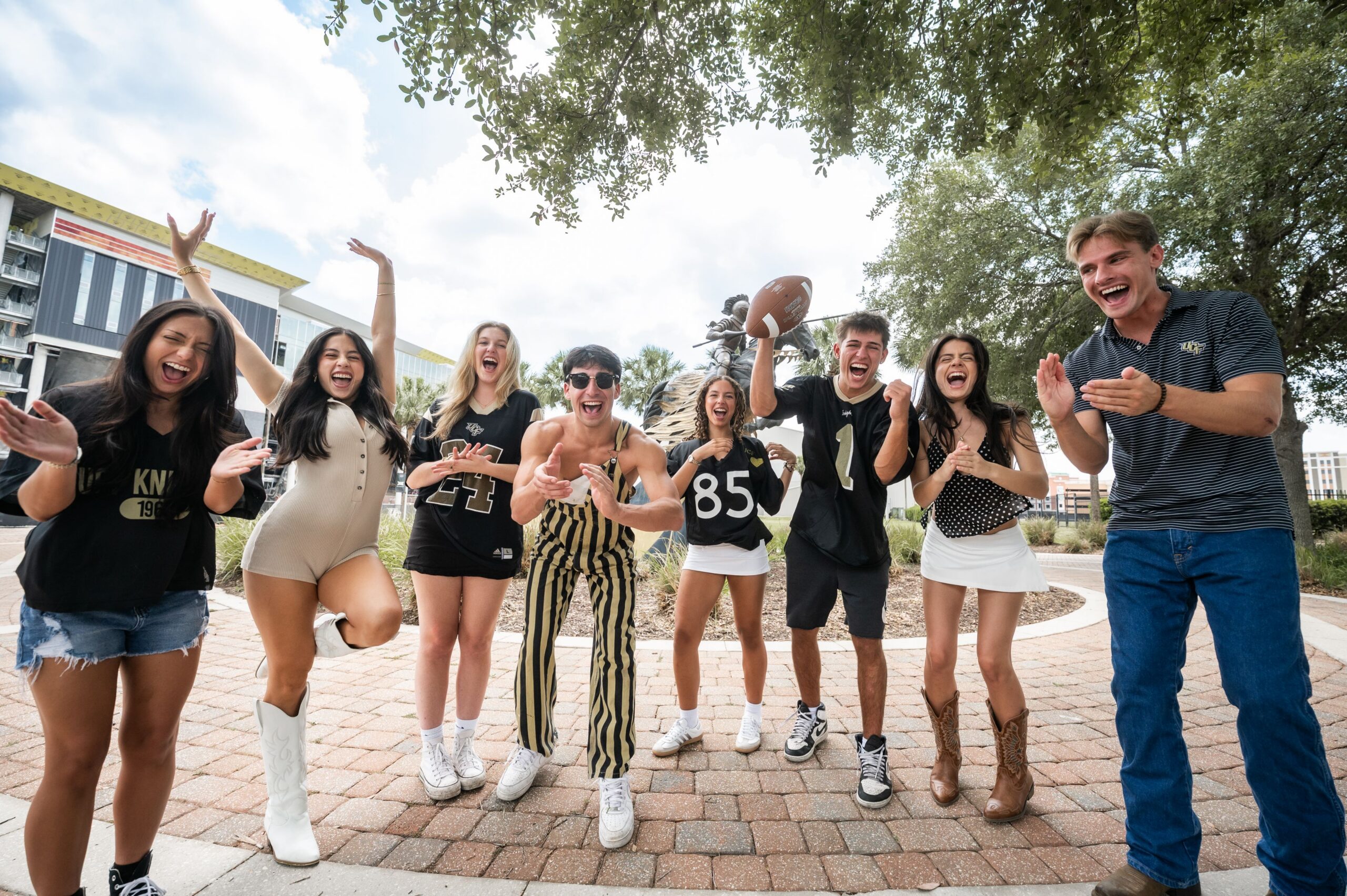 enthusiastic university fans cheering outdoors scaled