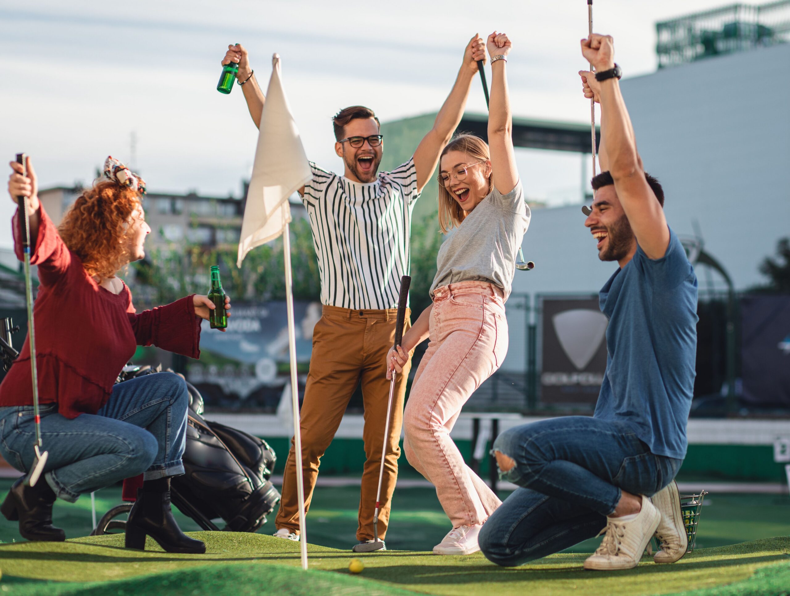 friends celebrating mini golf course scaled