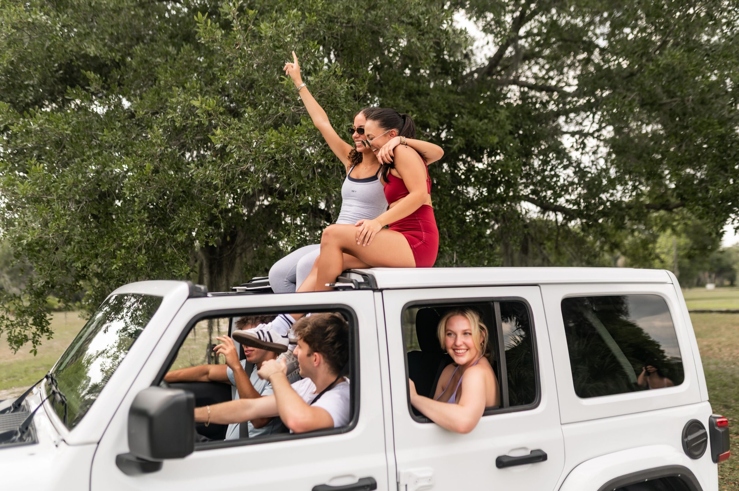friends on outdoor suv road trip scaled