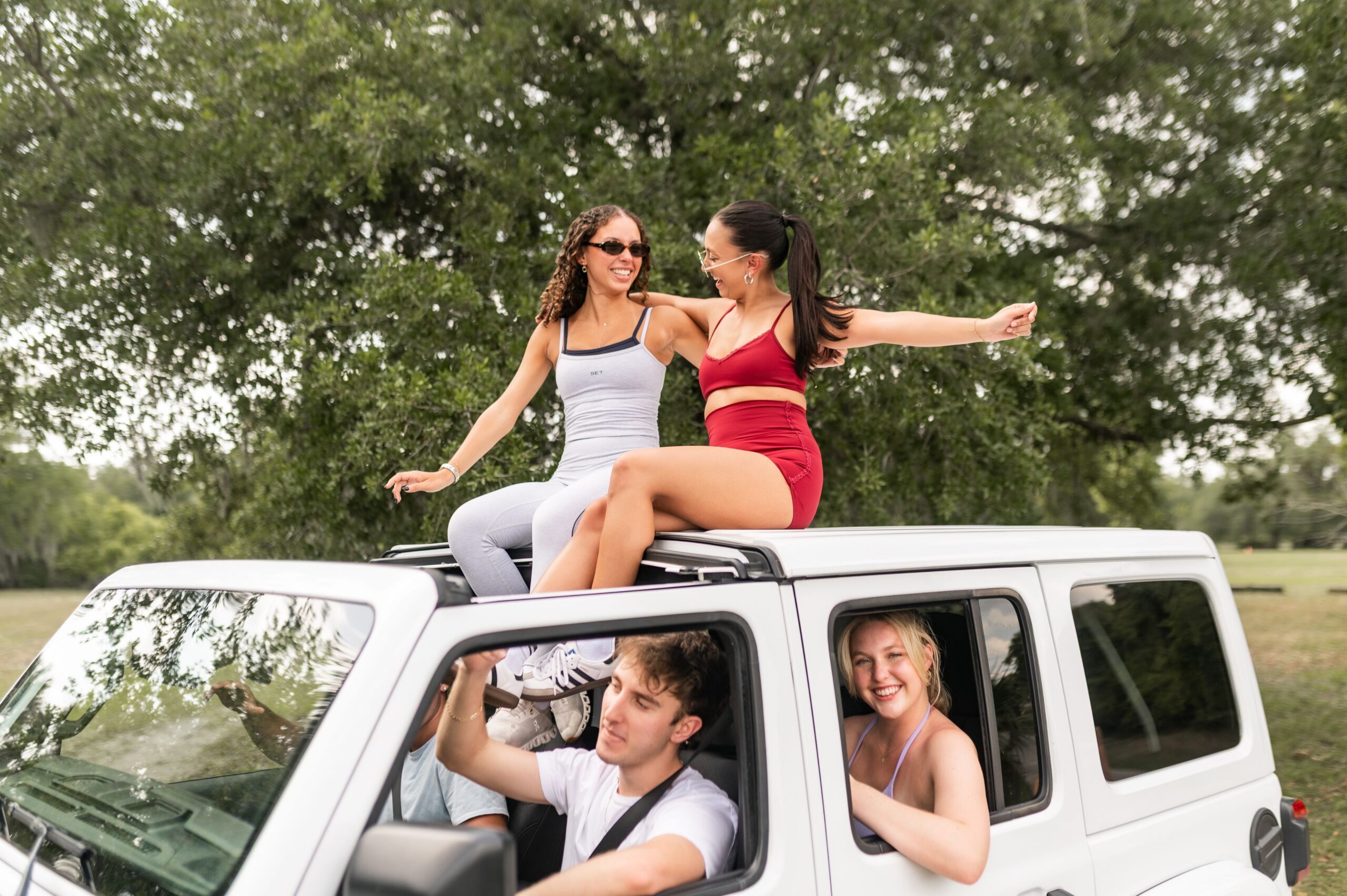 friends posing on off road vehicle scaled