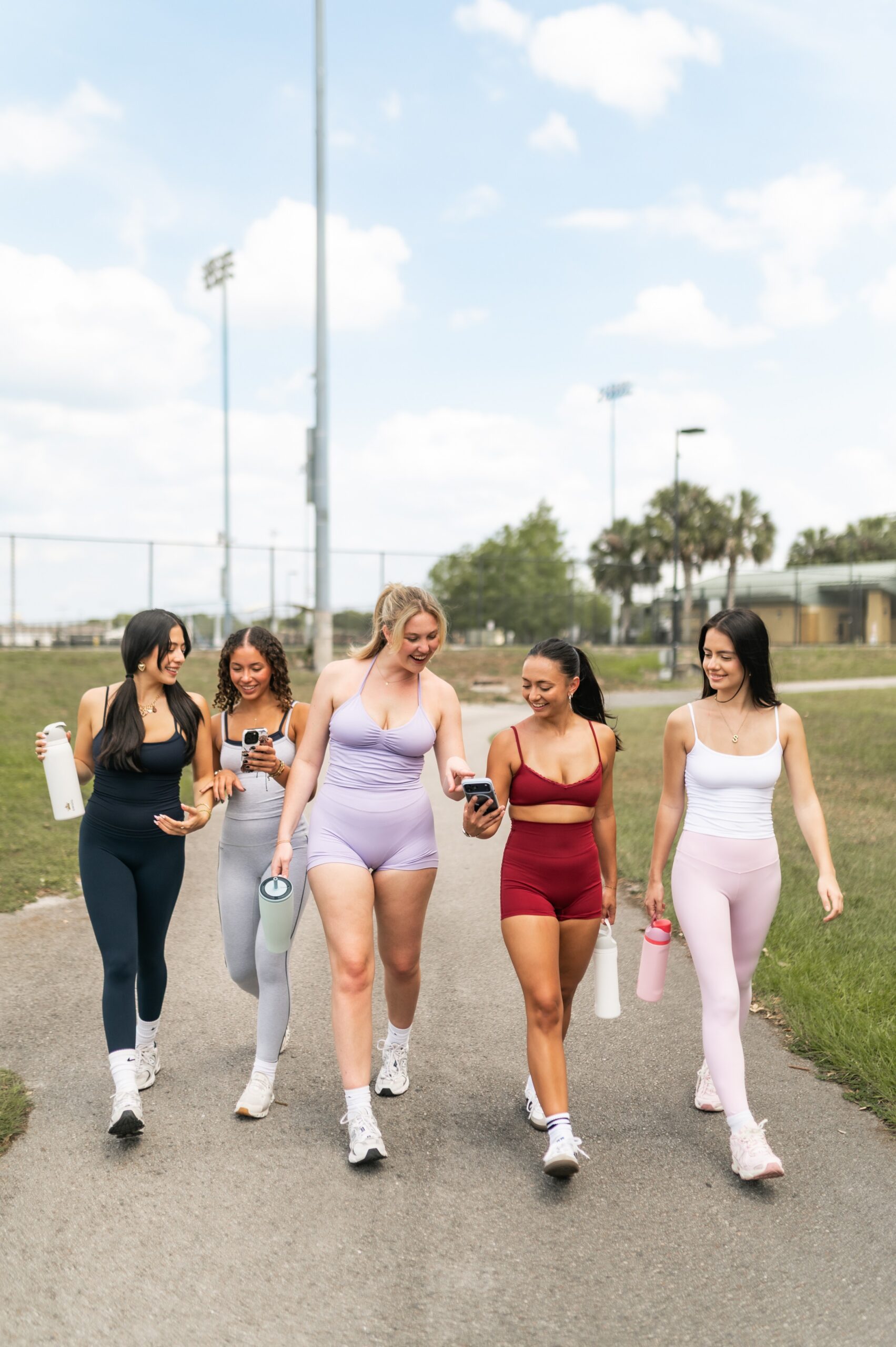 friends walking on paved park pathway scaled