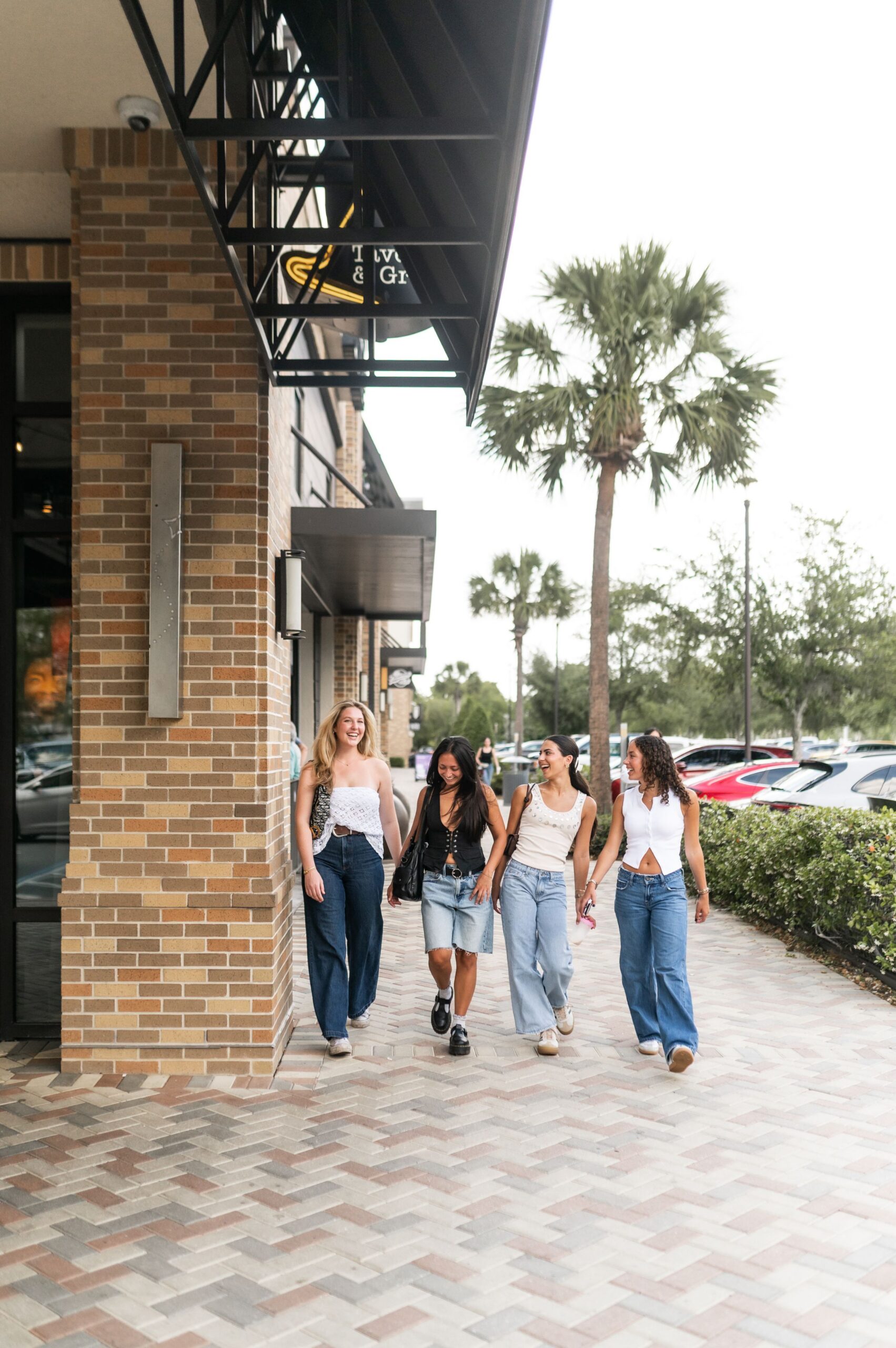 friends walking past retail storefront scaled