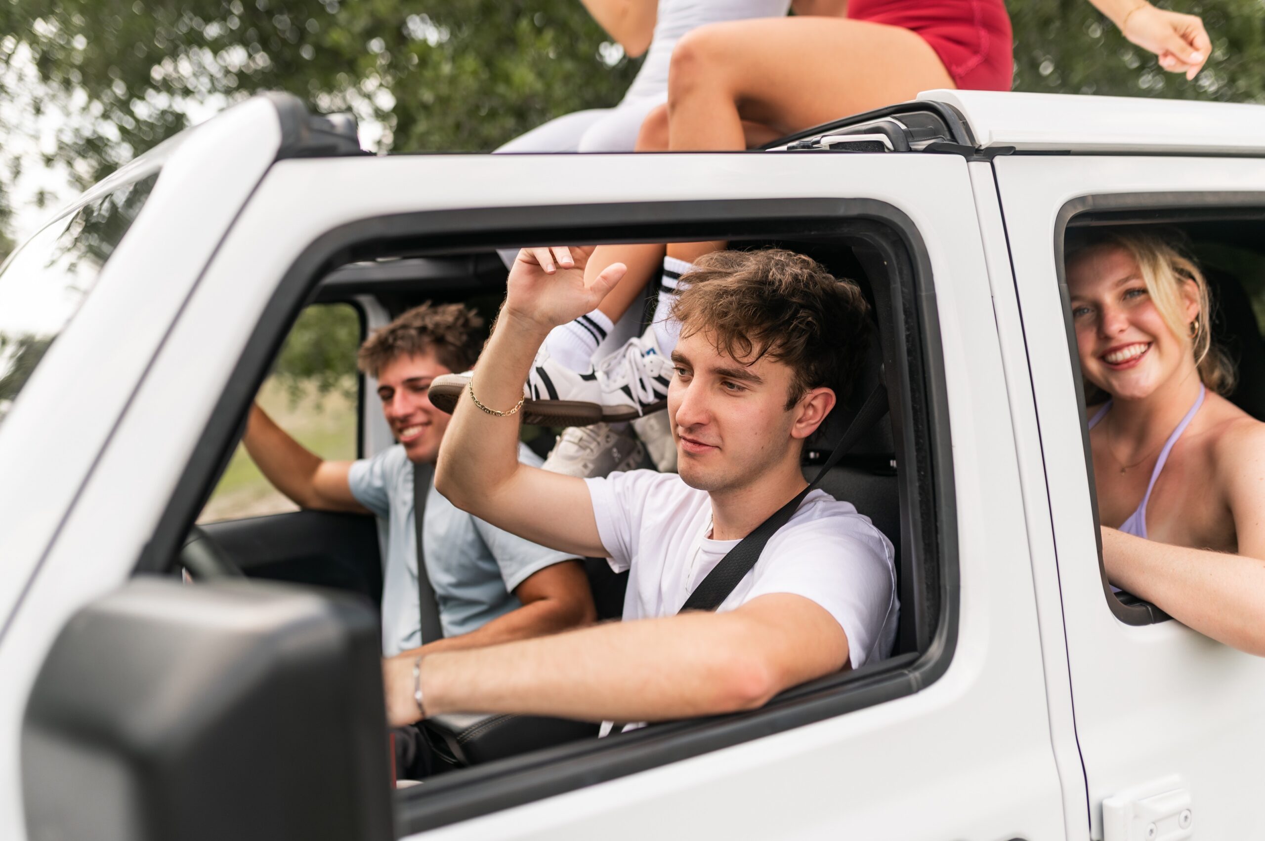 group socializing in white offroad vehicle scaled