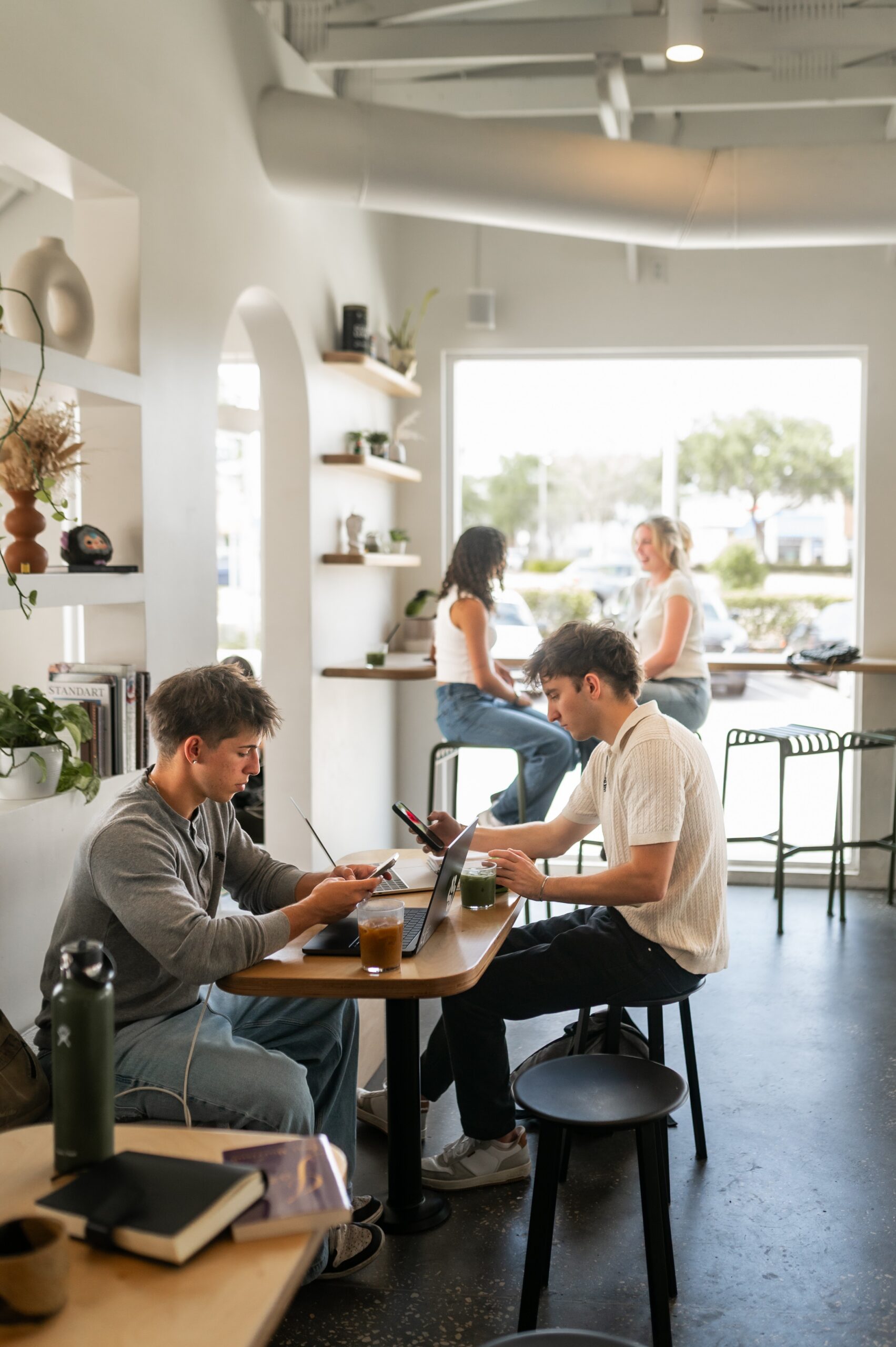 people working at cafe tables scaled