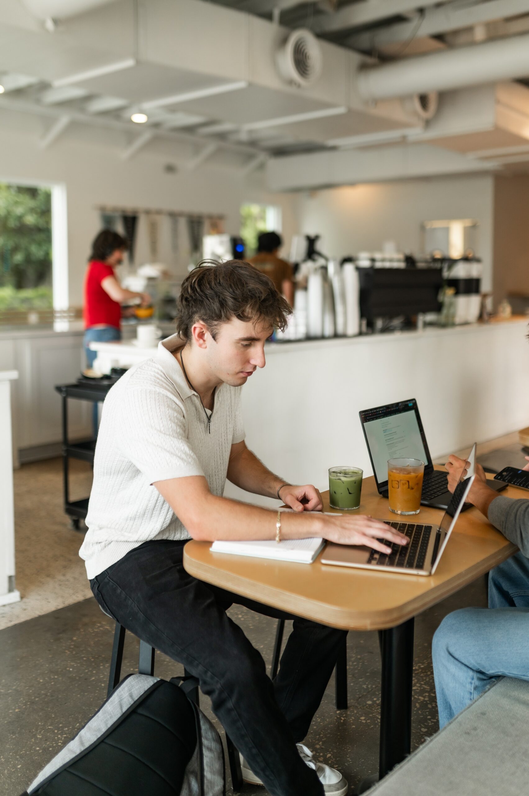 remote workers collaborating at cafe table scaled