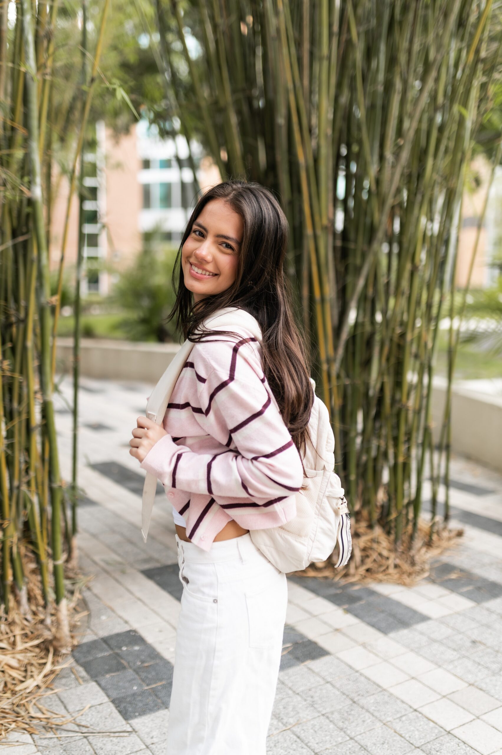 student walking past bamboo garden scaled