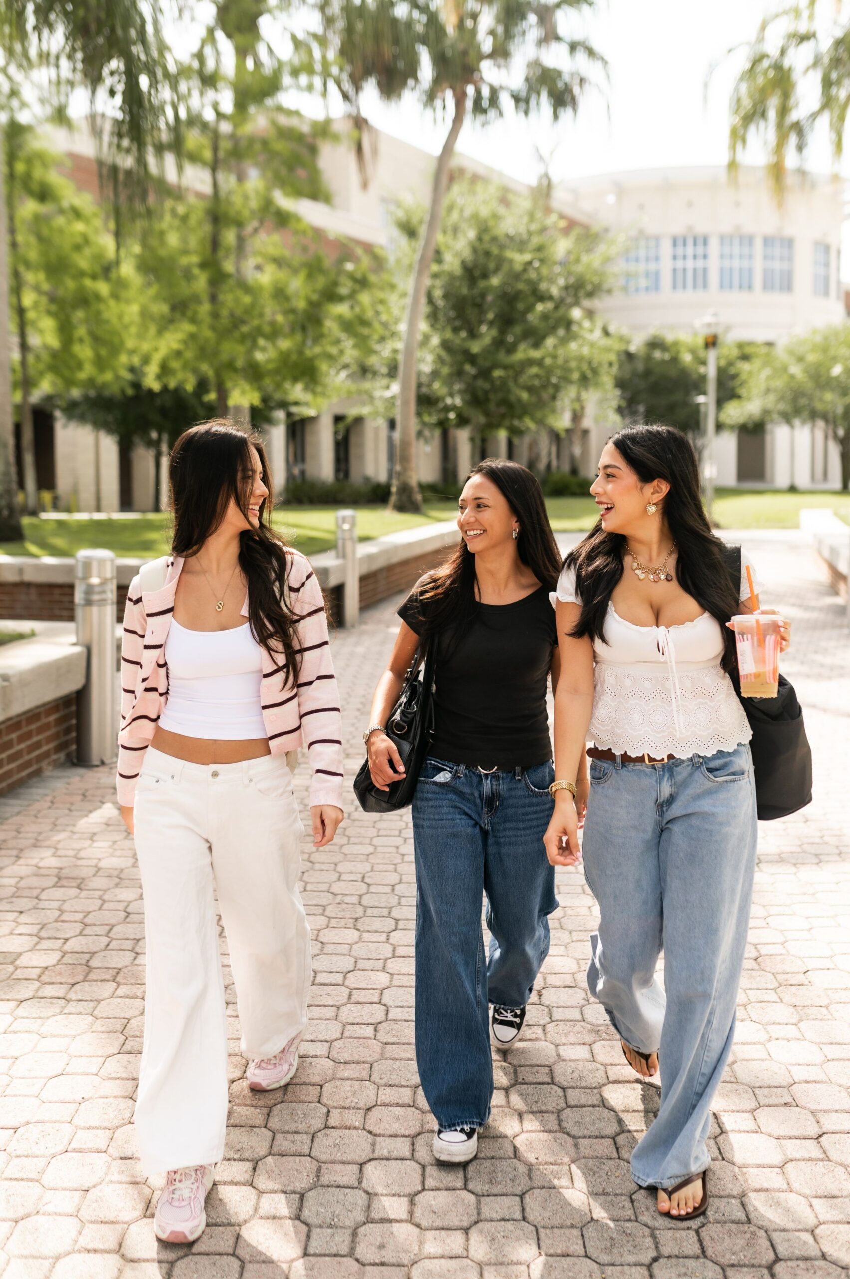university students strolling across campus grounds scaled