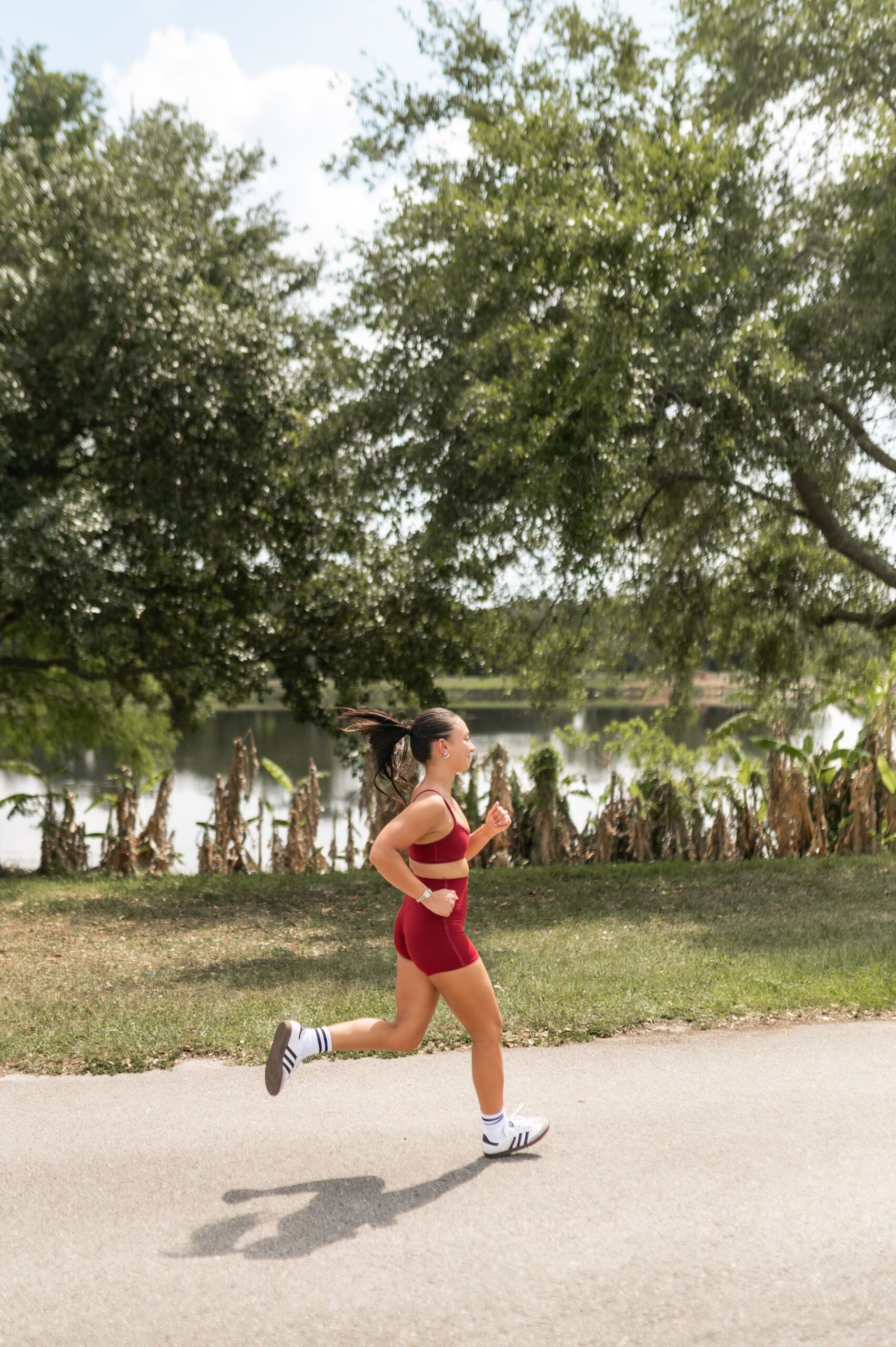 woman jogging on paved park trail scaled