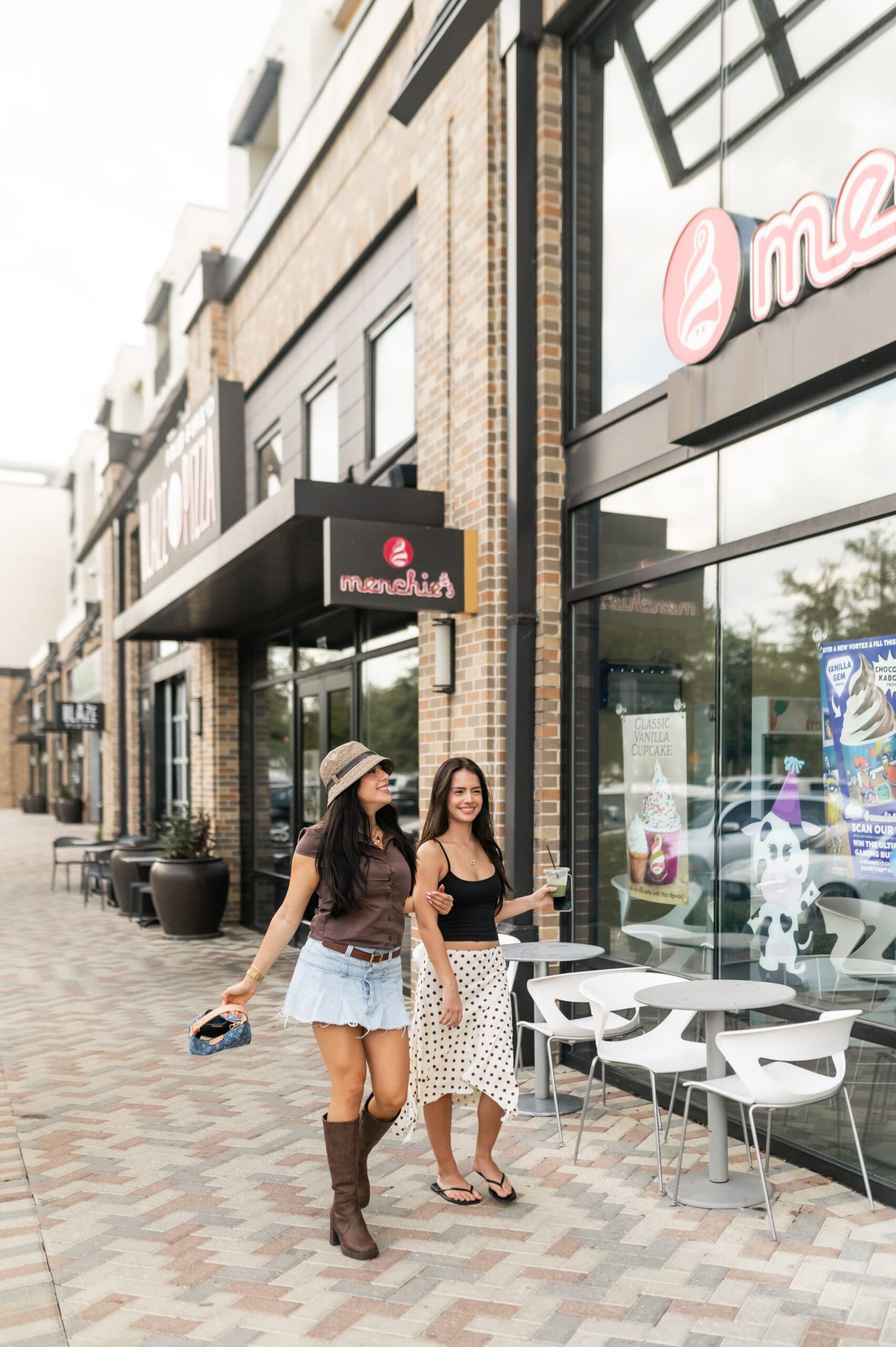 women strolling past retail storefronts scaled