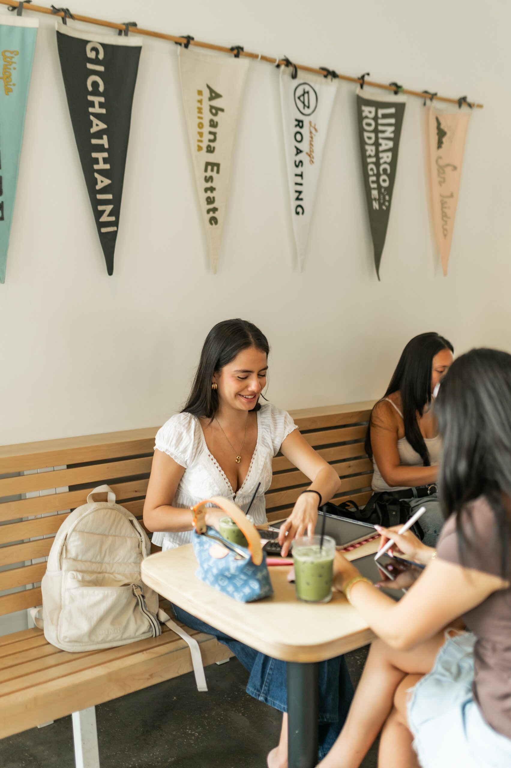 women using tablets at coffee roastery scaled