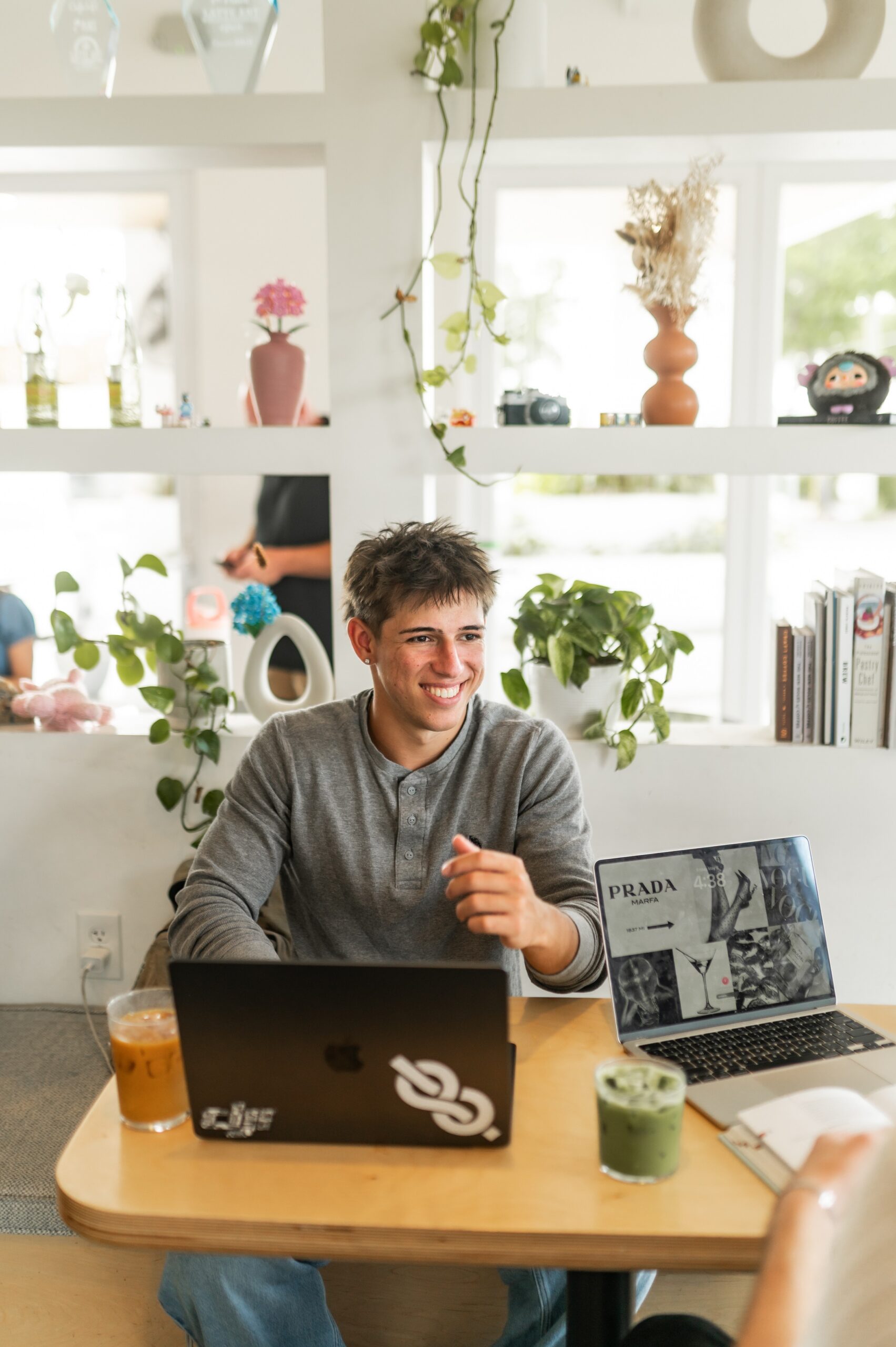 young man working at cafe table scaled