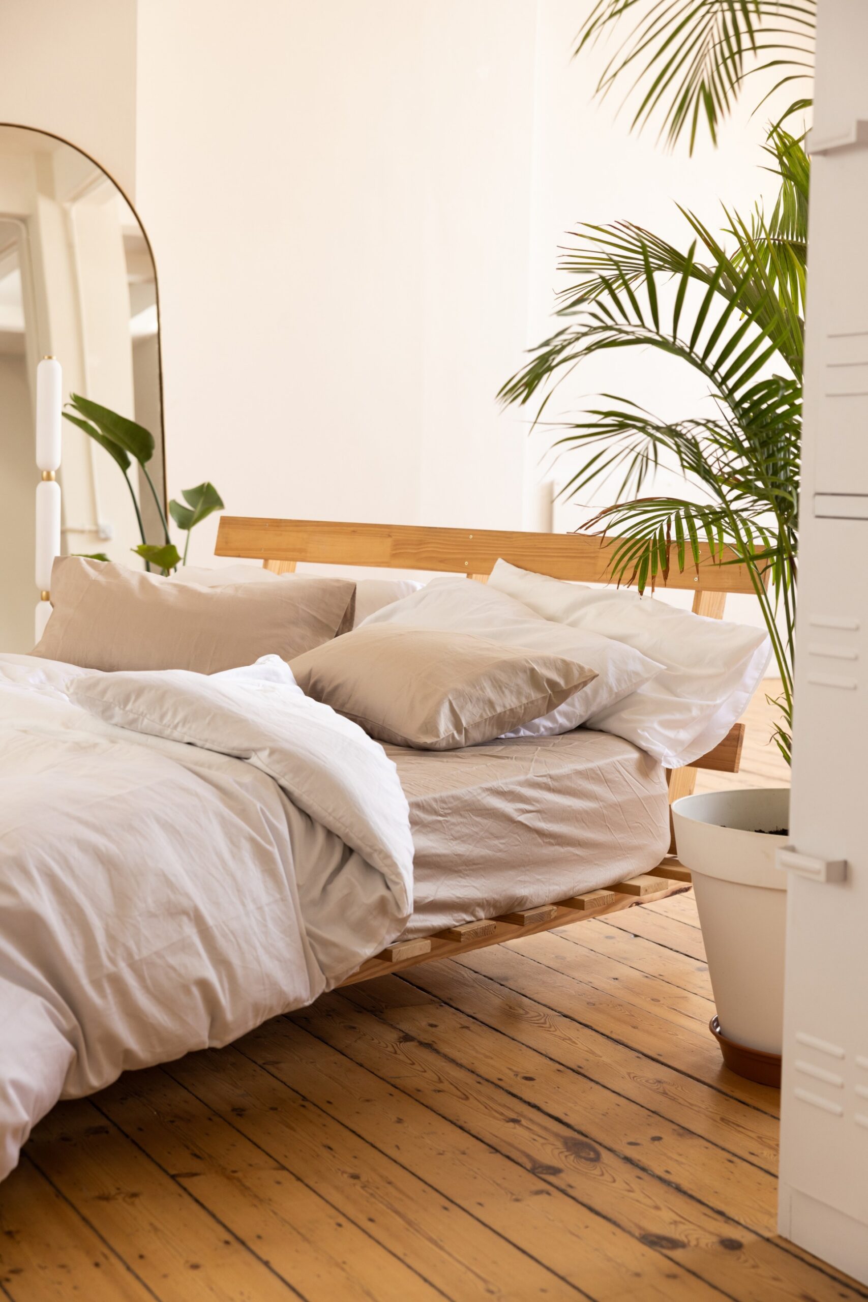 Minimalist bedroom with linen bedding and plants scaled